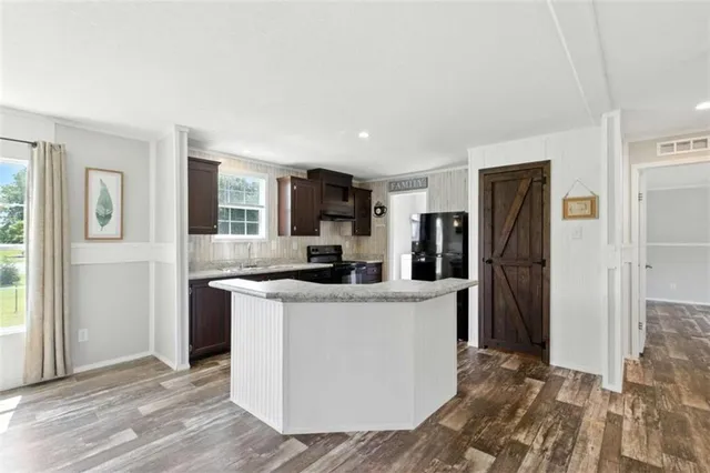 a view of a kitchen with a stove cabinets and wooden floor
