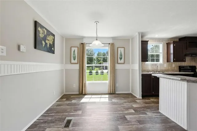a view of a bedroom with a bed and wooden floor