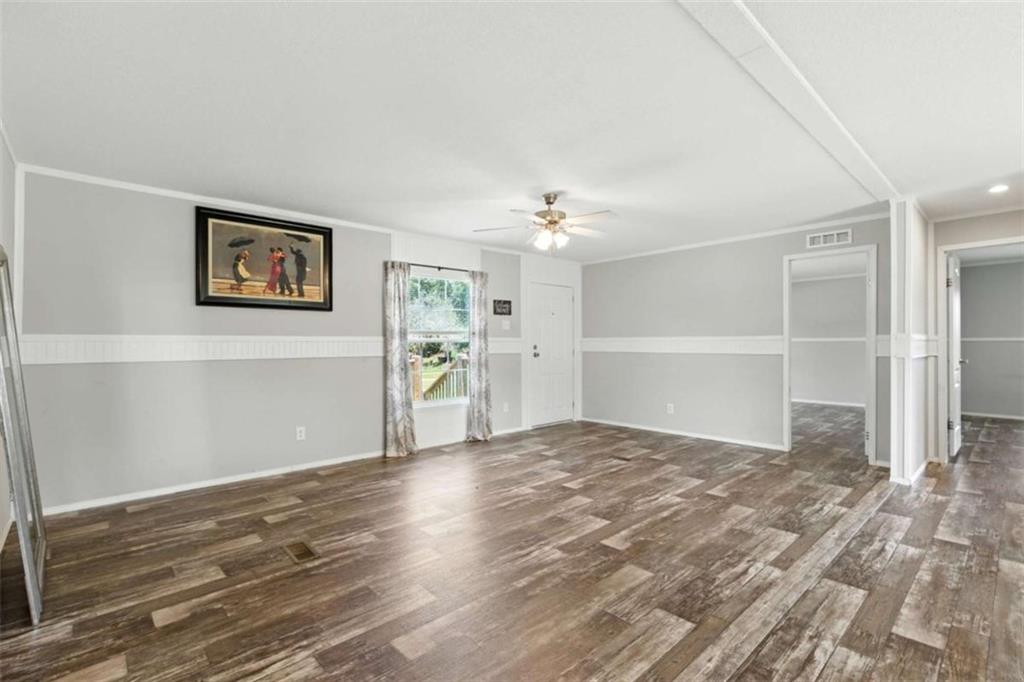 120 Beck Road Mount Airy, GA 30563 - Photo 7 of 30 a view of a big room with wooden floor and windows