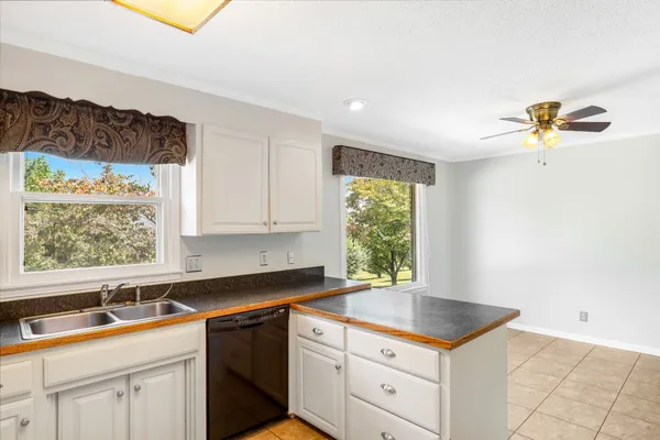 a kitchen with a sink cabinets and window
