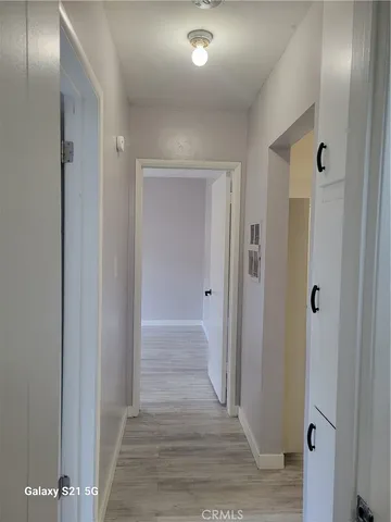 a view of a hallway with wooden floor