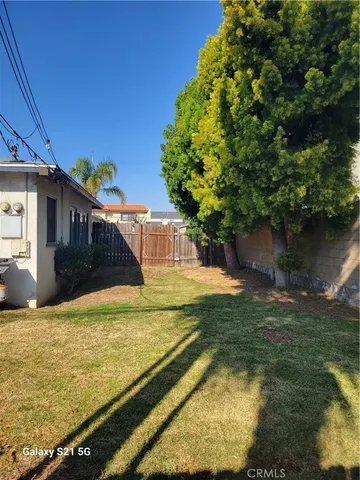 a view of a house with pool and a yard