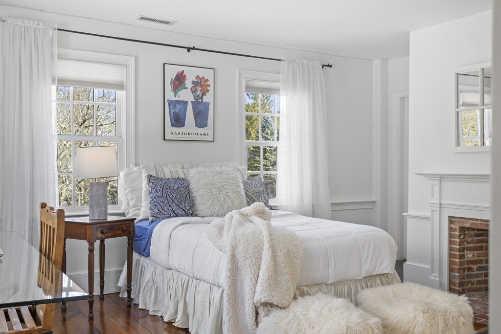 135 Plympton Road Sudbury, MA 01776 - Photo 29 of 42 a bedroom with a bed and a painting on the wall