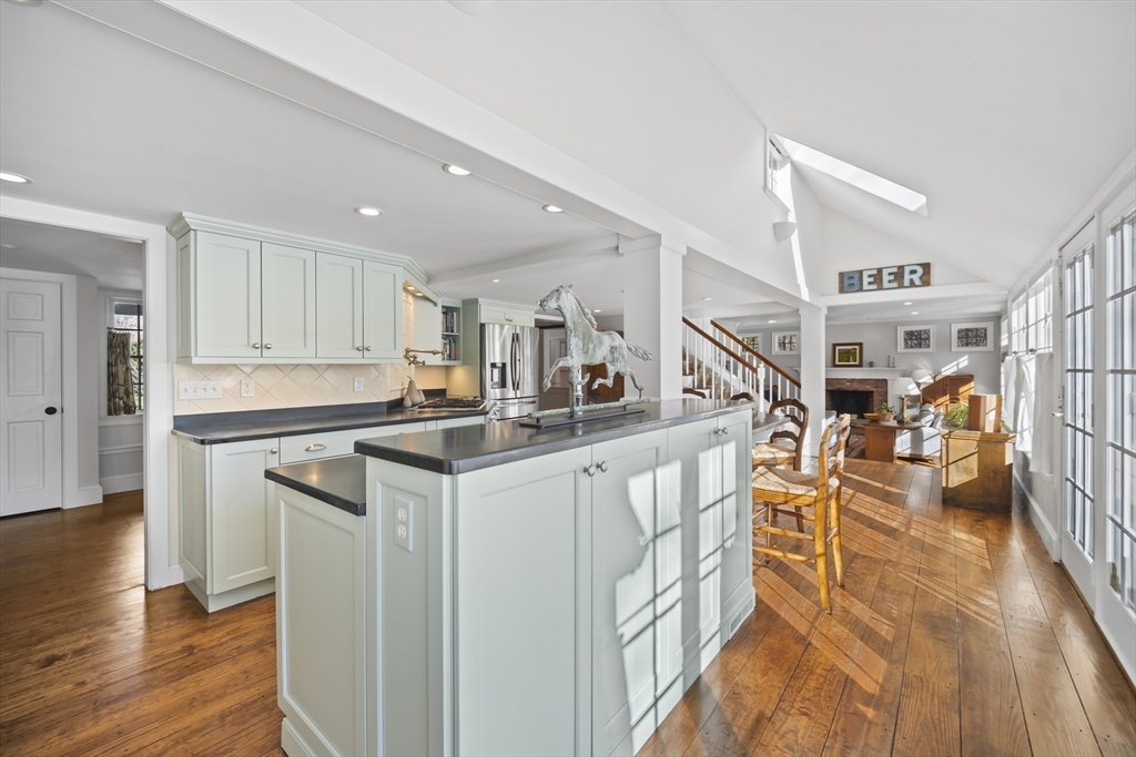 135 Plympton Road Sudbury, MA 01776 - Photo 9 of 42 a kitchen with stainless steel appliances granite countertop a refrigerator a stove and a wooden floors