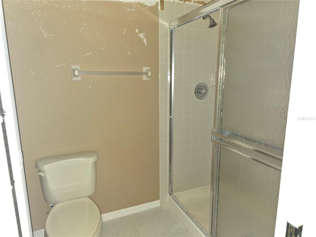 175 Kings Highway, Unit C8 Punta Gorda, FL 33983 - Photo 12 of 20 a bathroom with a toilet and a shower
