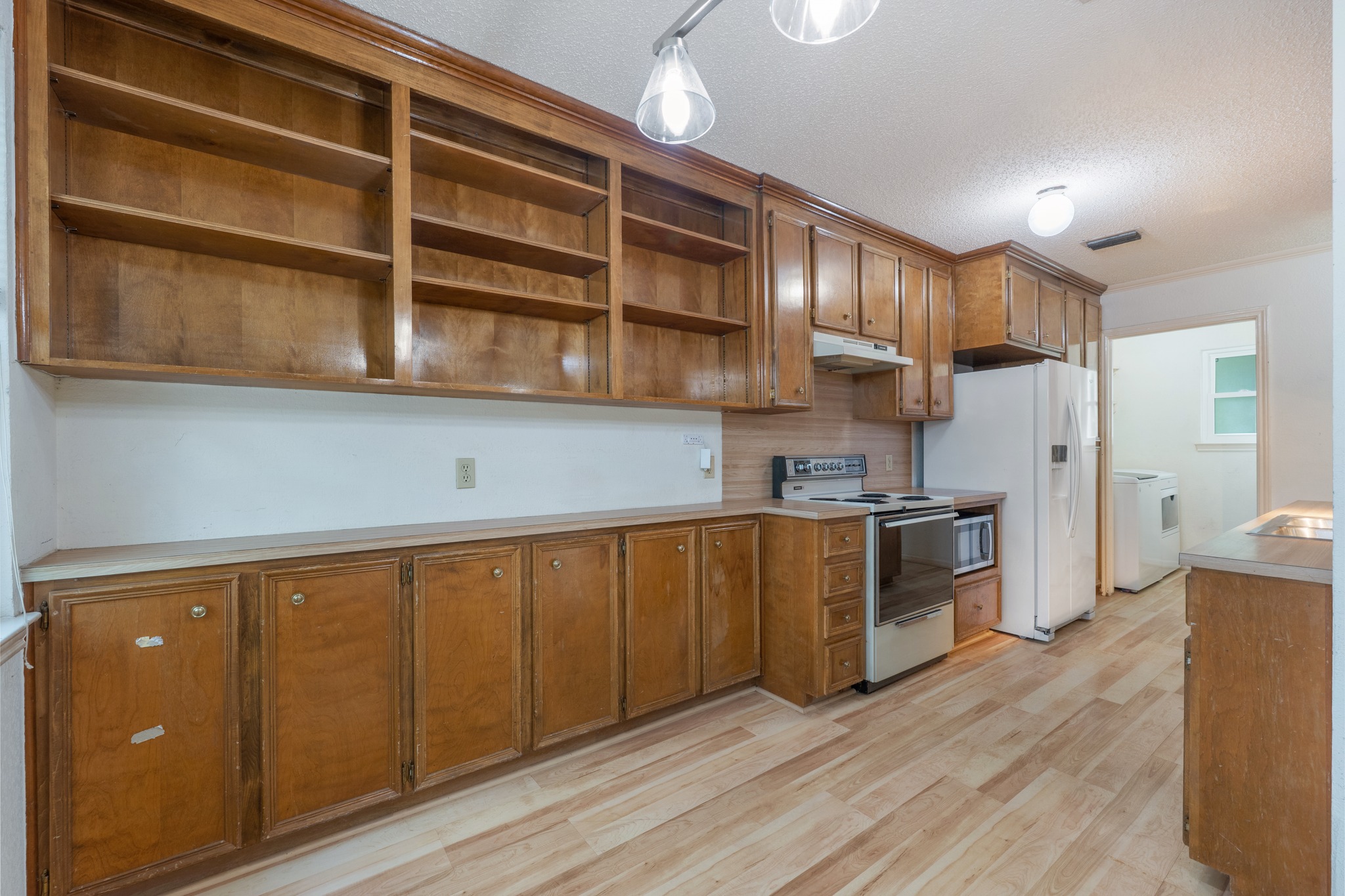 3845 Ranch Road 2222, Unit 19 Austin, TX 78731 - Photo 14 of 38 a kitchen with stainless steel appliances granite countertop a refrigerator a stove and a wooden floors