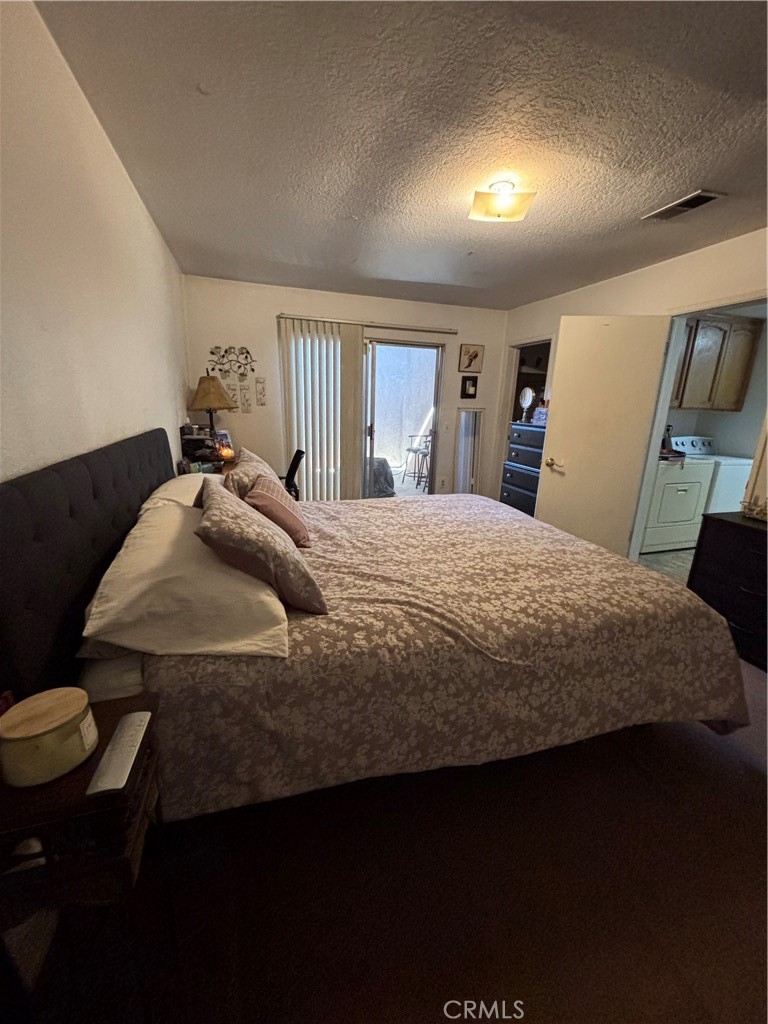 107 East Baseline Road San Dimas, CA 91773 - Photo 14 of 52 a bedroom with a bed a dresser and chair