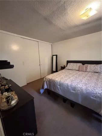 a bedroom with a bed and a night stand