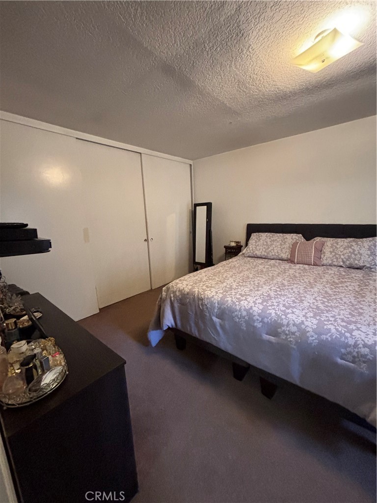 107 East Baseline Road San Dimas, CA 91773 - Photo 15 of 52 a bedroom with a bed and a night stand