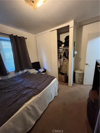 a bedroom with a bed and a mirror