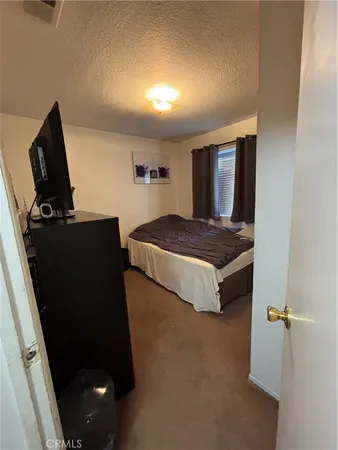 a bedroom with a bed and dresser