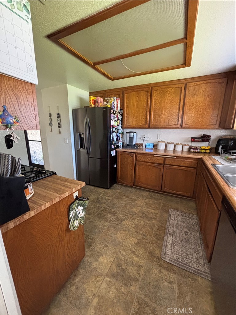 107 East Baseline Road San Dimas, CA 91773 - Photo 23 of 52 a kitchen with a stove a refrigerator and a sink