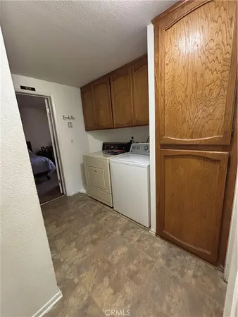 a storage room with wooden floor washer and dryer