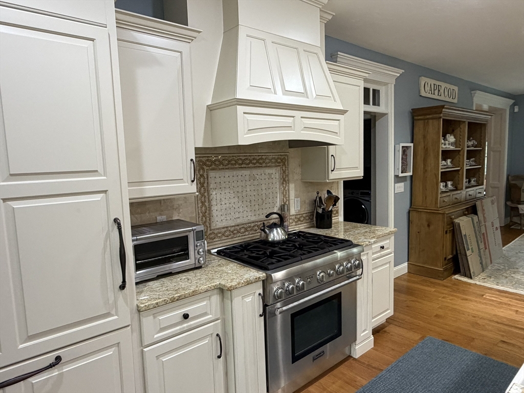 4 Tamarack Lane Sandwich, MA 02563 - Photo 12 of 42 a kitchen with stainless steel appliances granite countertop white cabinets and a stove