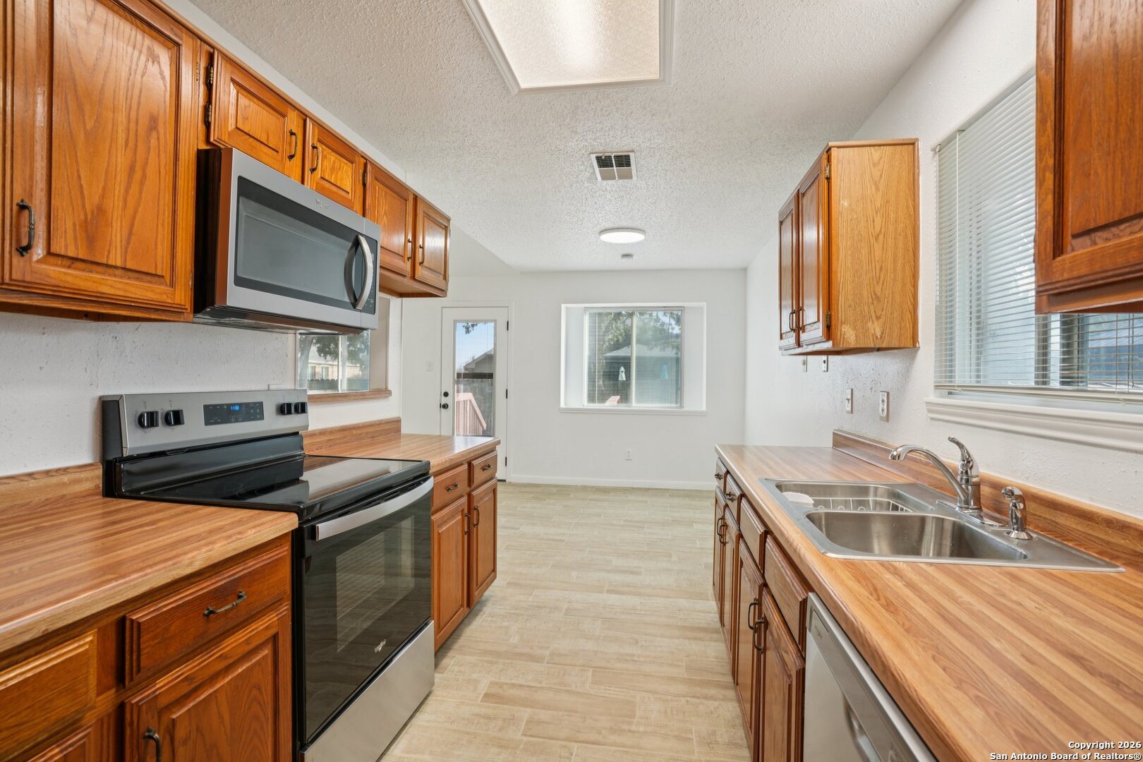 1012 Dimrock Schertz, TX 78154 - Photo 8 of 20 a kitchen that has a sink and a stove