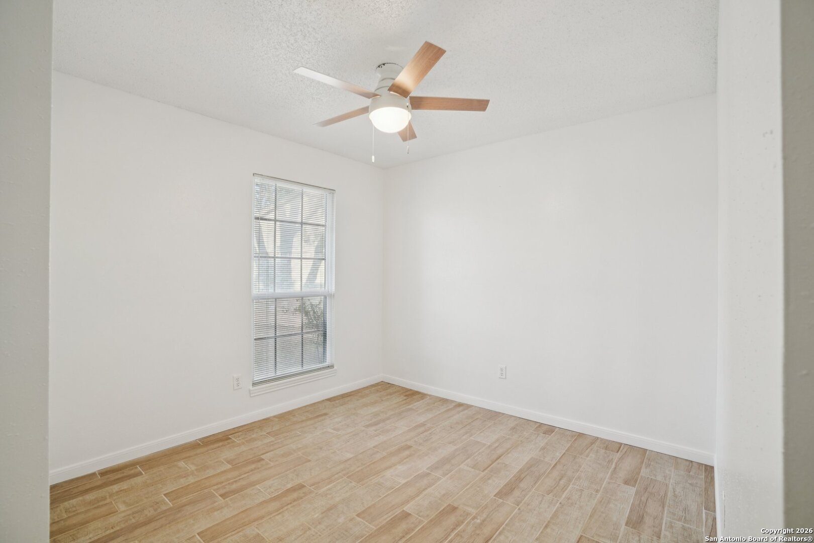 1012 Dimrock Schertz, TX 78154 - Photo 9 of 20 an empty room with wooden floor fan and windows