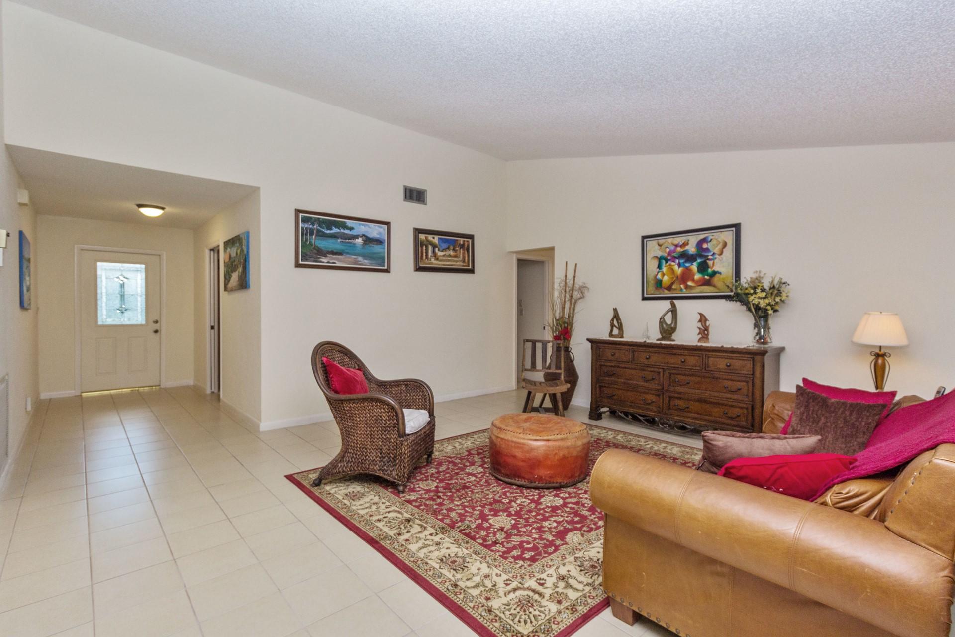 7883 Cloverfield Circle Boca Raton, FL 33433 - Photo 3 of 25 a living room with furniture and a wooden floor