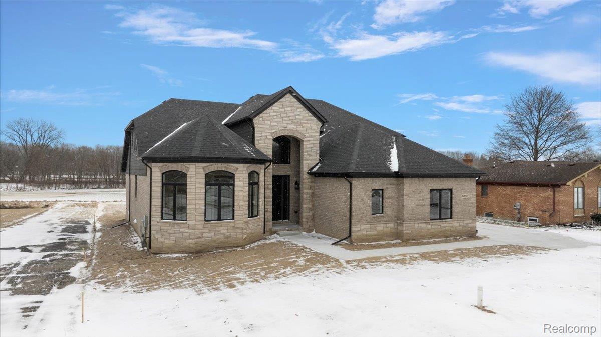 53650 Romeo Plank Road Macomb, MI 48042 - Photo 3 of 64 View of front of home featuring stone siding and a shingled roof