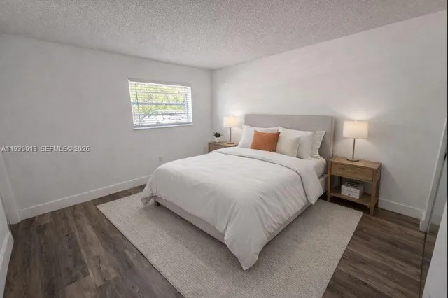 a bedroom with a bed and a night stand