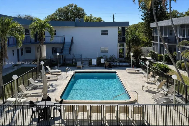 a view of a house with backyard and sitting area