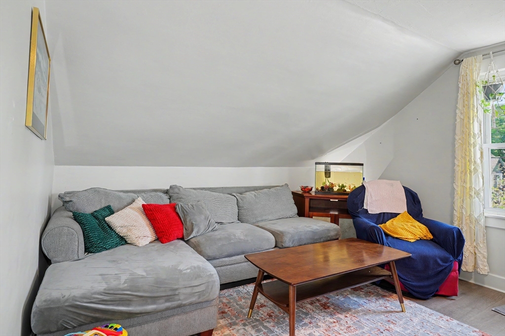5 Eddy Street, Unit 2 Webster, MA 01570 - Photo 13 of 18 a living room with furniture and a window