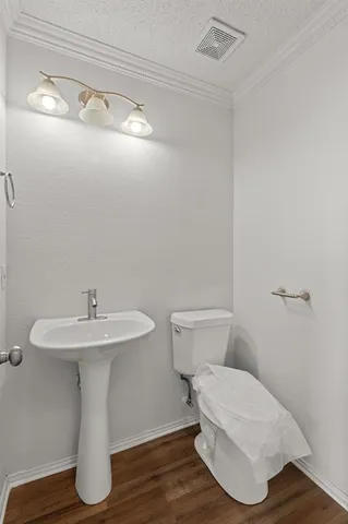 a bathroom with a sink toilet and a mirror