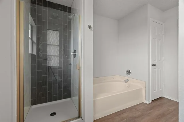 a bathroom with a bathtub and a shower