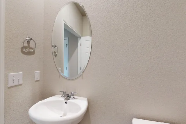 a bathroom with a shower sink and mirror