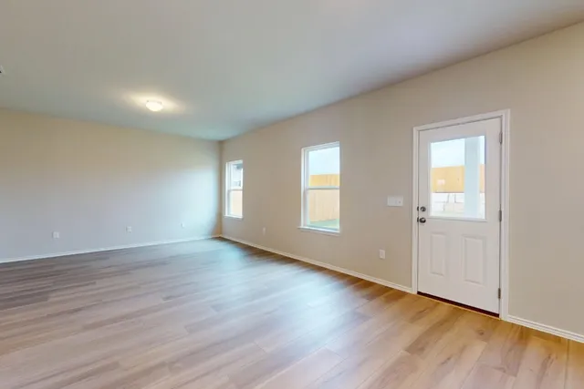 a kitchen with kitchen island white cabinets appliances and wooden floor