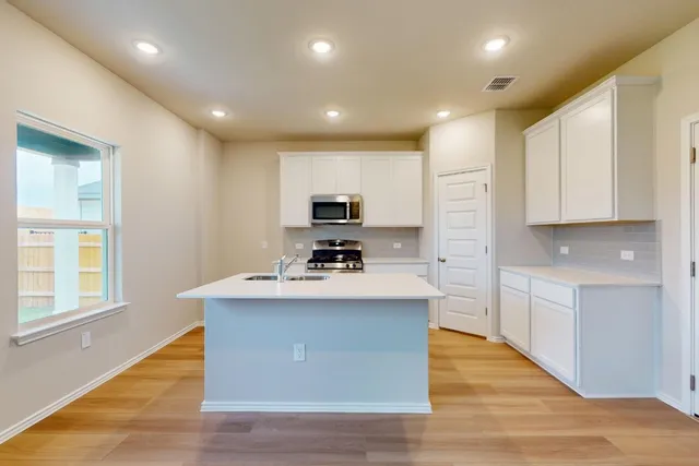 a kitchen with a stove a sink and a refrigerator