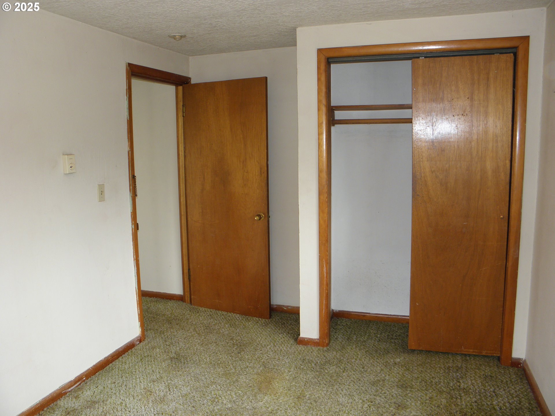 6640 Southeast 66th Avenue Portland, OR 97206 - Photo 16 of 21 a view of an empty room with closet and wooden floor