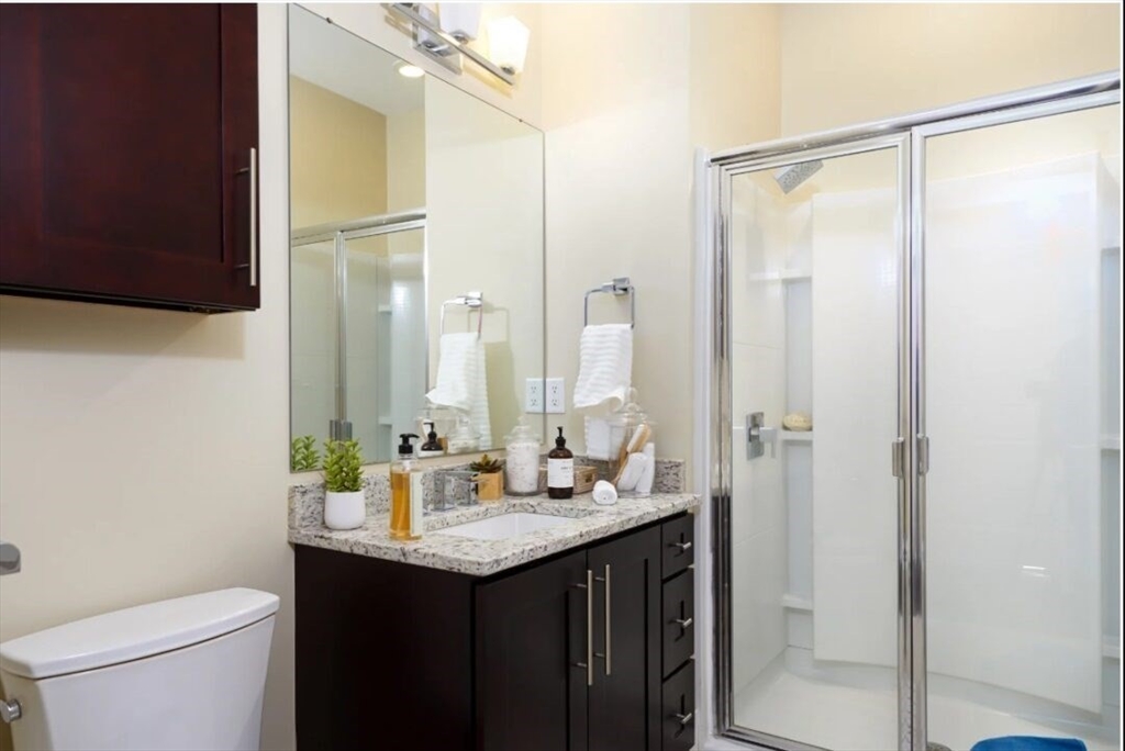 1000 Matrix Way, Unit 2204 Hudson, MA 01749 - Photo 5 of 7 a bathroom with a double vanity sink toilet and a mirror