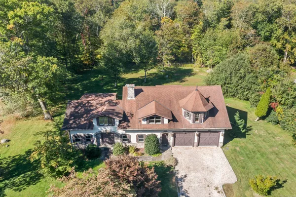 an aerial view of a house with yard and outdoor seating