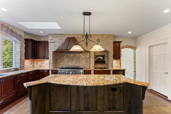 a kitchen with stainless steel appliances granite countertop a stove and a sink