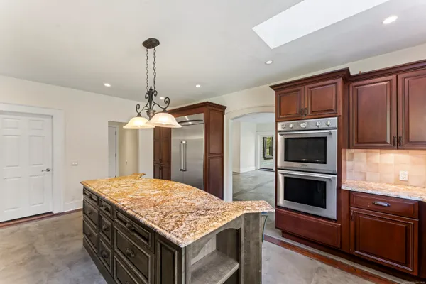 a kitchen with a stove and a kitchen island
