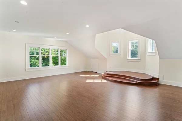 a view of a livingroom with wooden floor and pool table