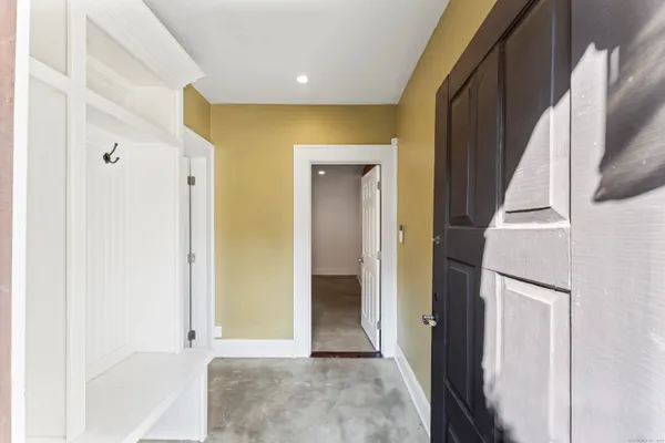 a view of a hallway with wooden shelves