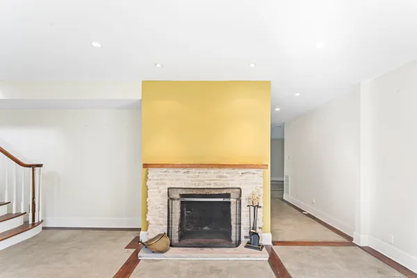 a living room with a fireplace and a table