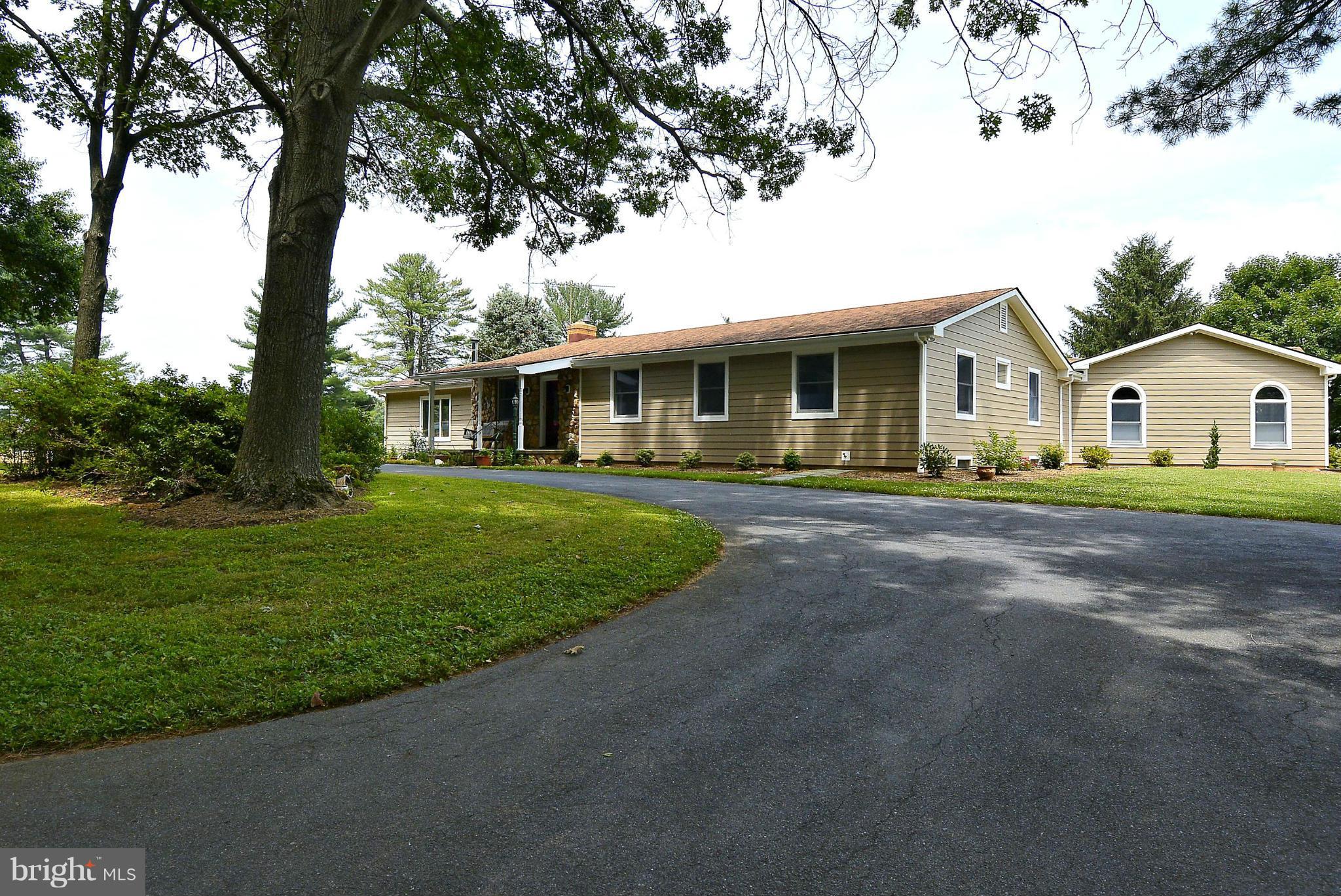 21121 Peach Tree Road Dickerson, MD 20842 - Photo 1 of 30 a front view of a house with a garden and trees