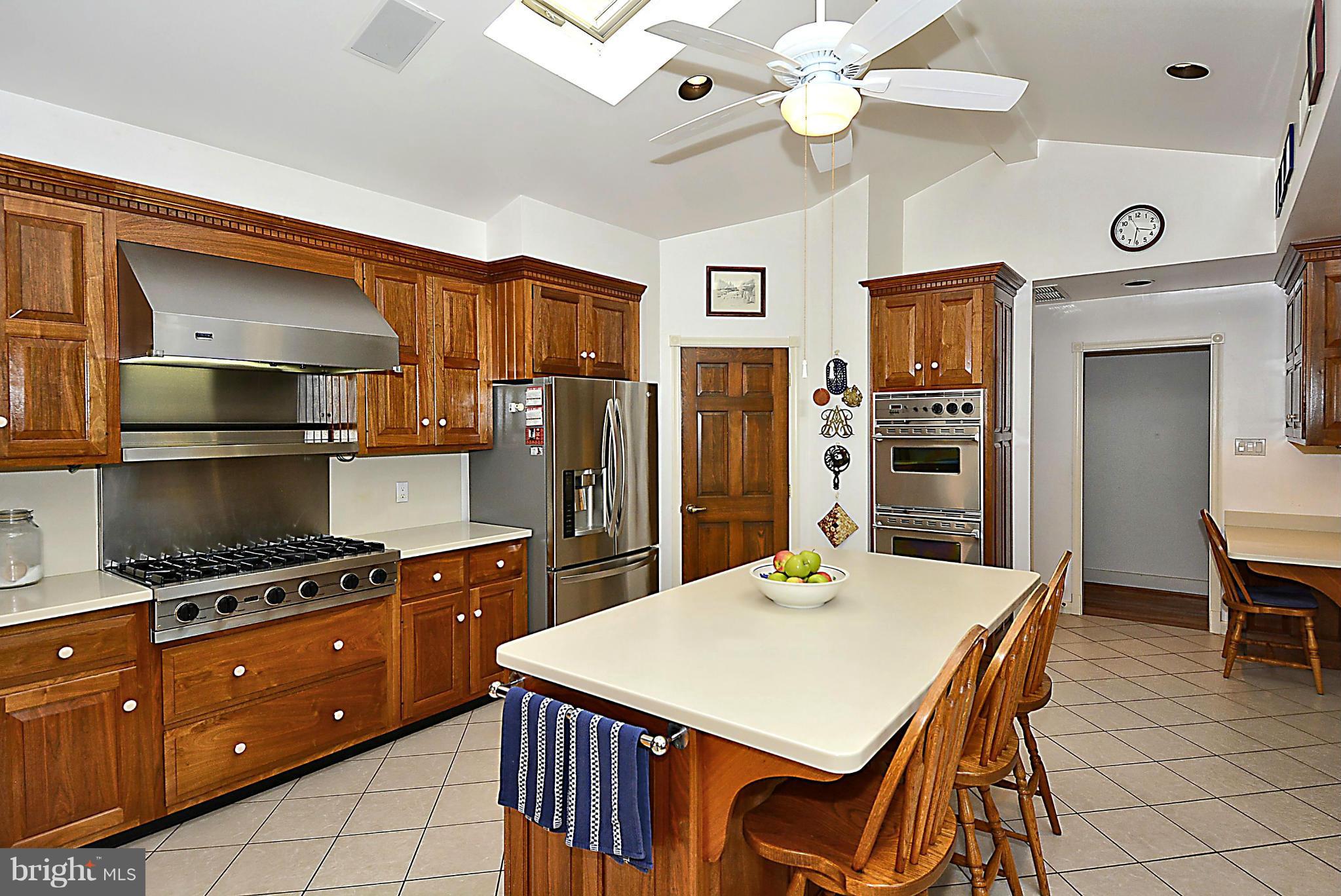 21121 Peach Tree Road Dickerson, MD 20842 - Photo 11 of 30 a kitchen with granite countertop a table chairs stainless steel appliances and cabinets