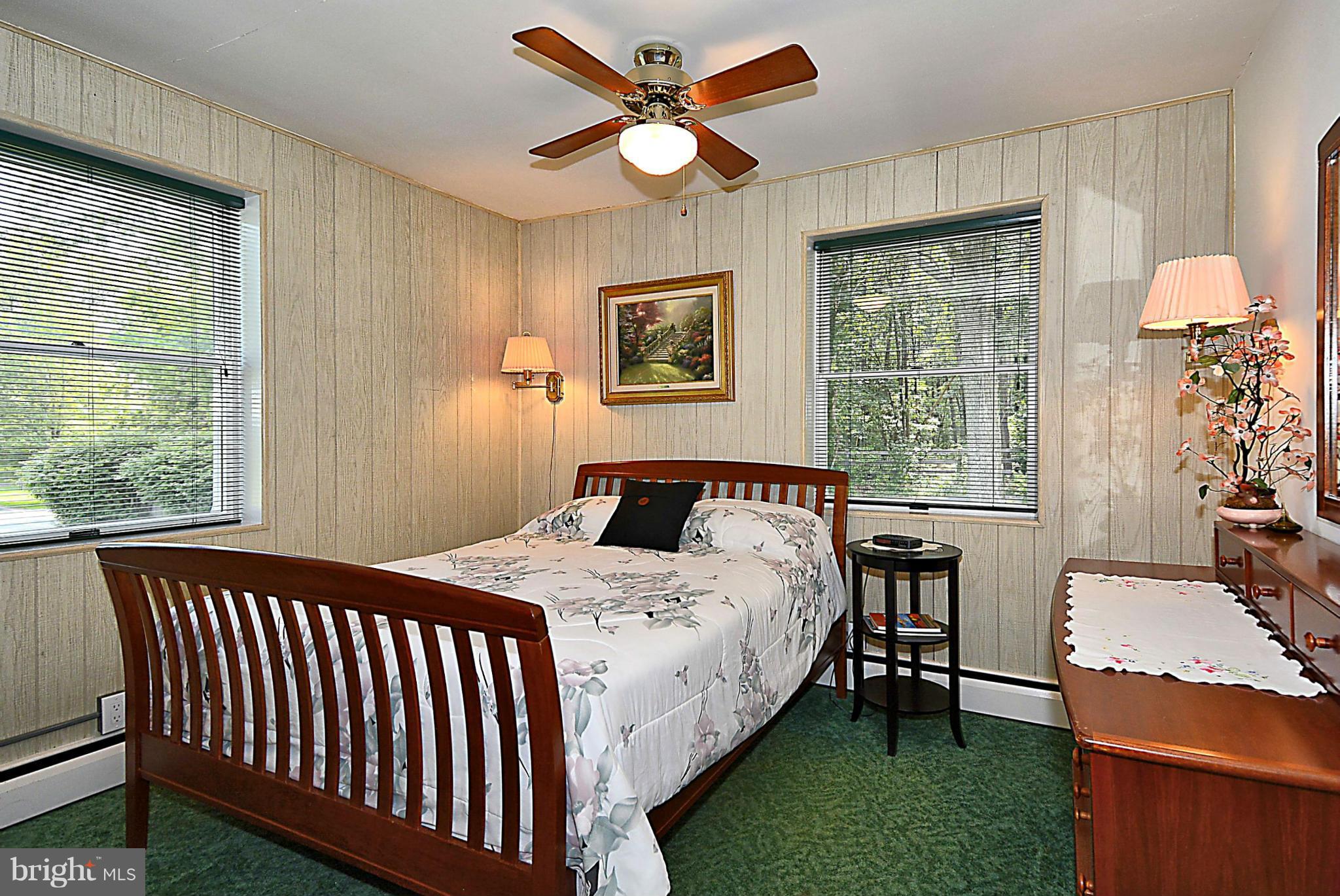 21121 Peach Tree Road Dickerson, MD 20842 - Photo 15 of 30 a bedroom with a bed and a table with chair