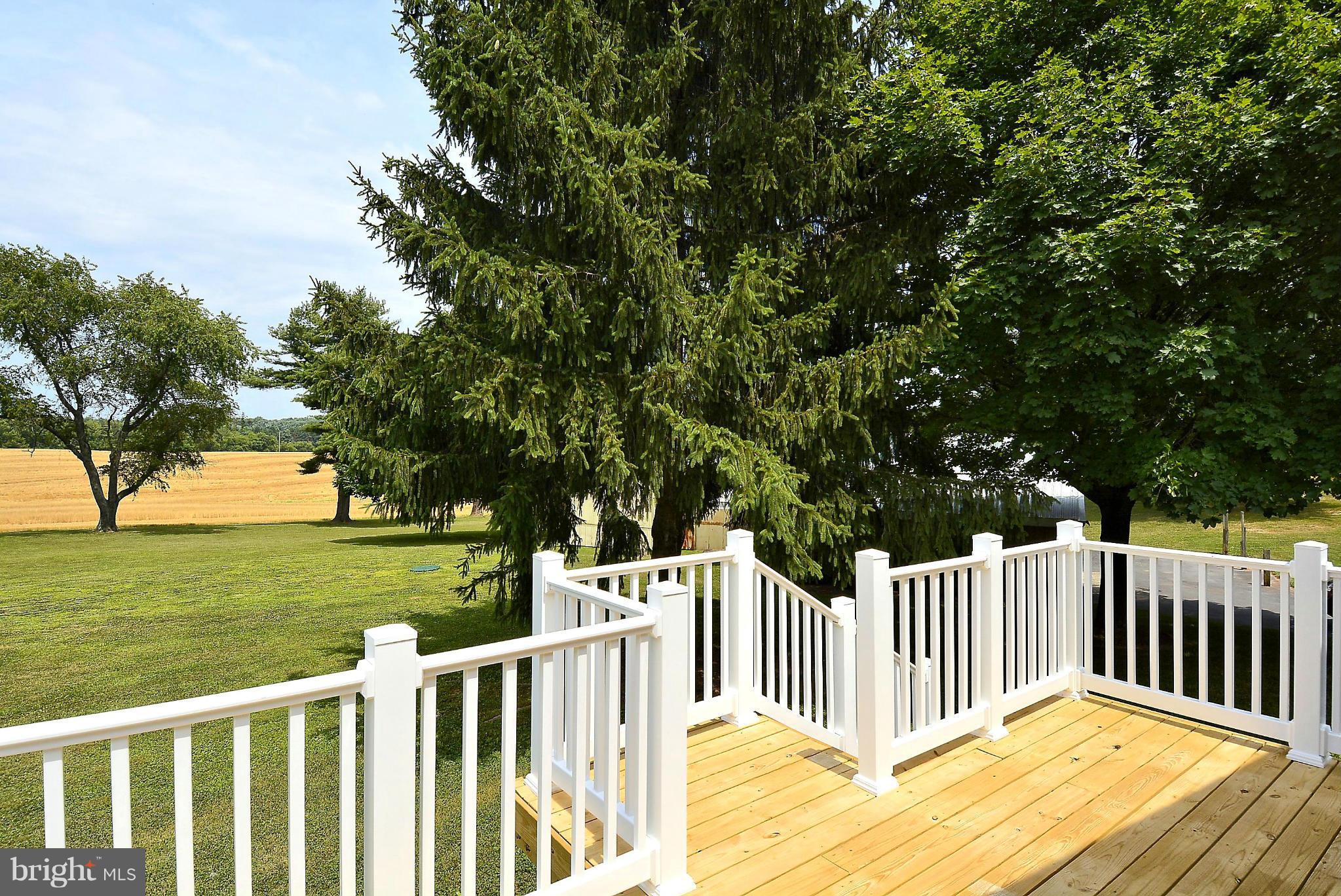 21121 Peach Tree Road Dickerson, MD 20842 - Photo 28 of 30 a view of a deck with a white house and a yard with wooden fence