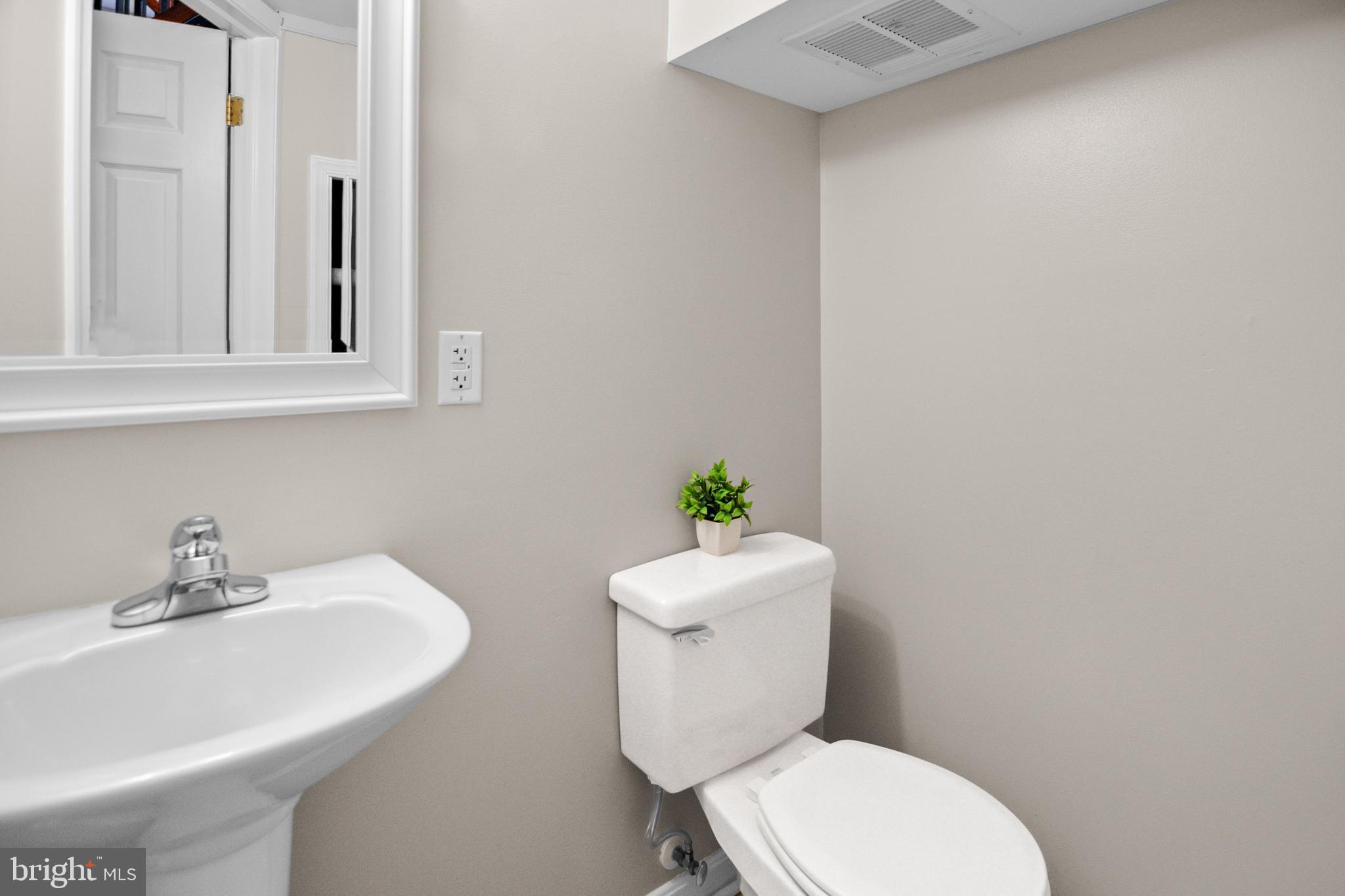 1535 South Hanover Street Baltimore, MD 21230 - Photo 15 of 43 a white toilet sitting next to a bathroom sink