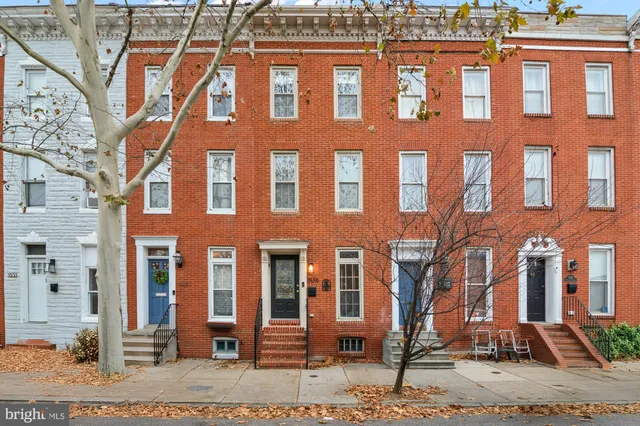 a view of a balcony with furniture and wooden floor