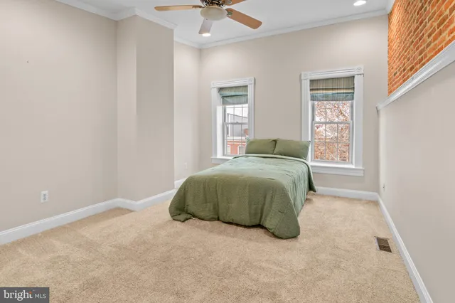 a view of a brick house with a wooden fence