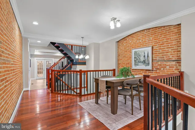 a view of a balcony with furniture and wooden floor