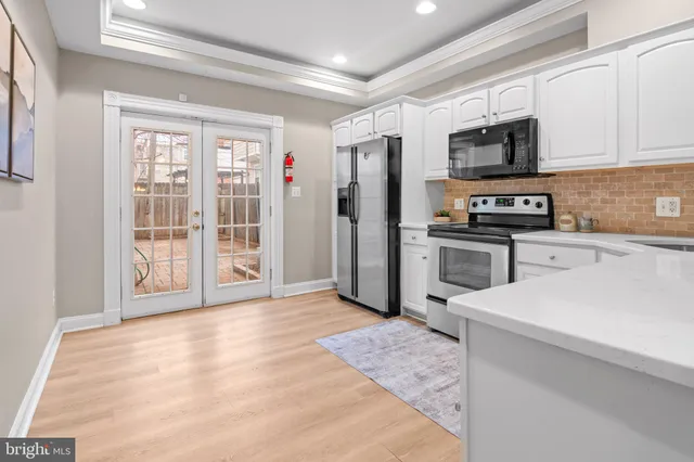 a living room with furniture and a book shelf