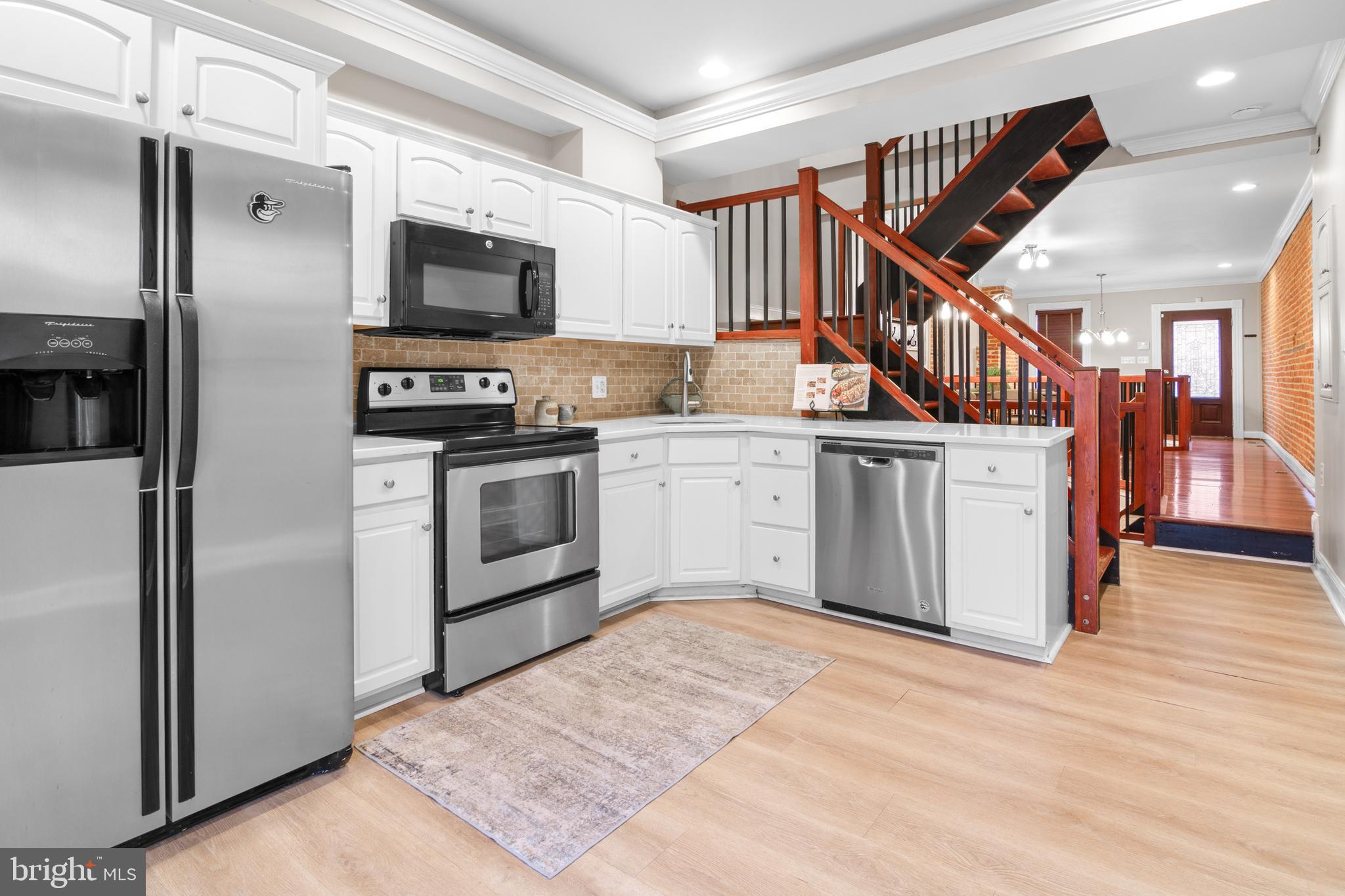 1535 South Hanover Street Baltimore, MD 21230 - Photo 9 of 43 a kitchen with stainless steel appliances granite countertop a stove top oven and sink