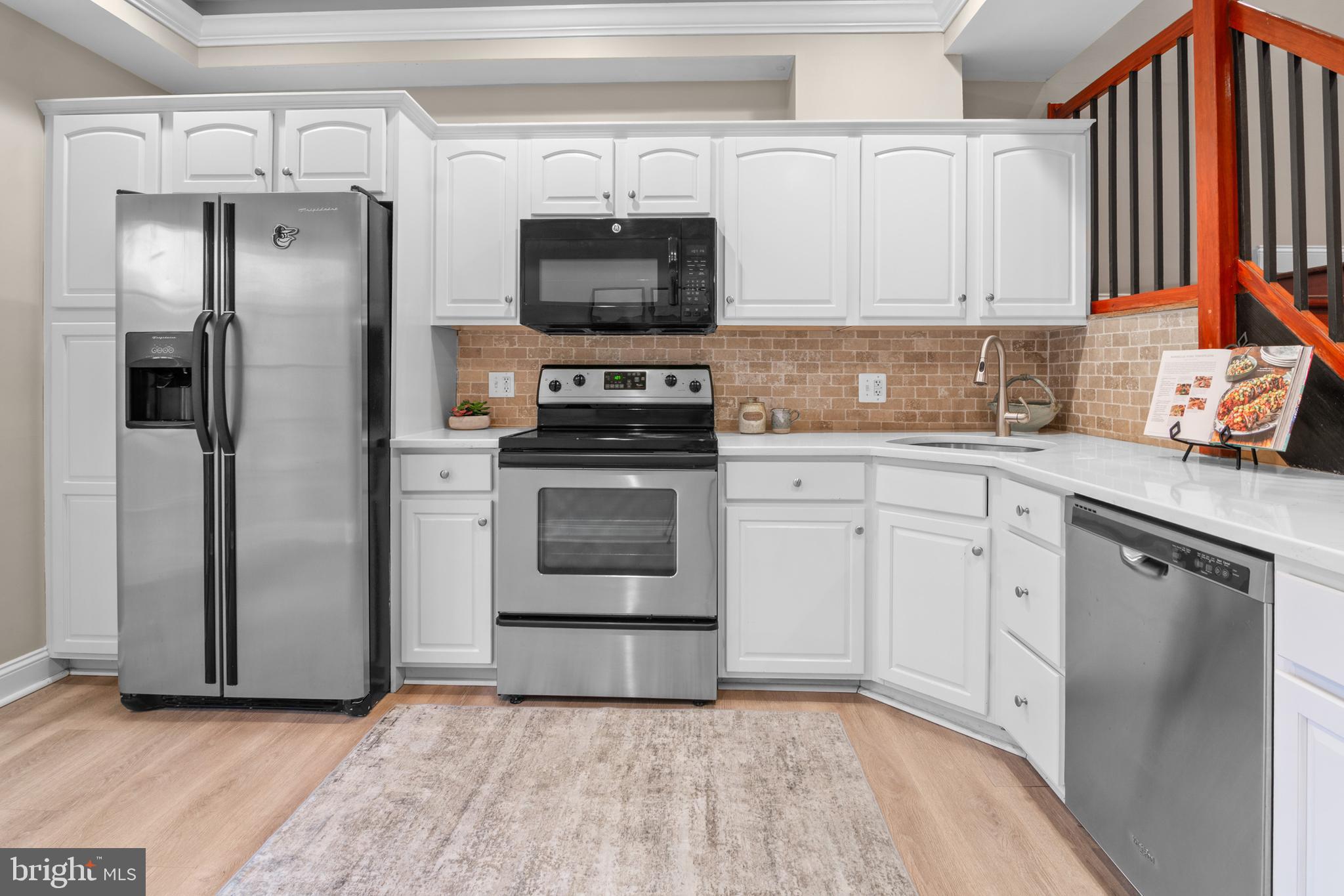 1535 South Hanover Street Baltimore, MD 21230 - Photo 10 of 43 a kitchen with stainless steel appliances a refrigerator sink and microwave