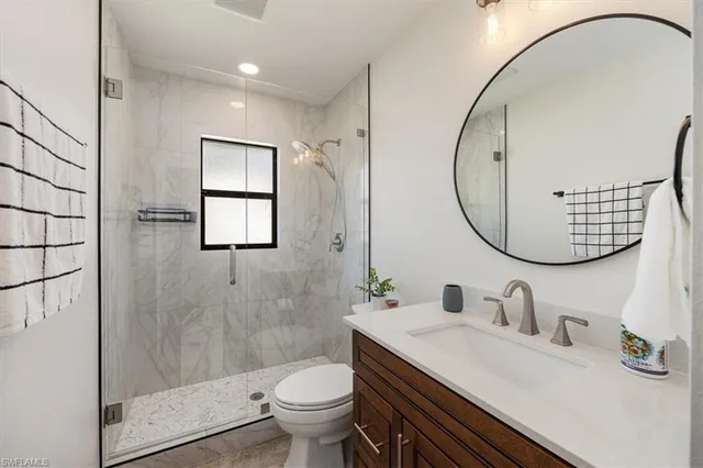 a bedroom with a bed a table and chair